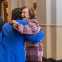 President Mantella hugging event guest